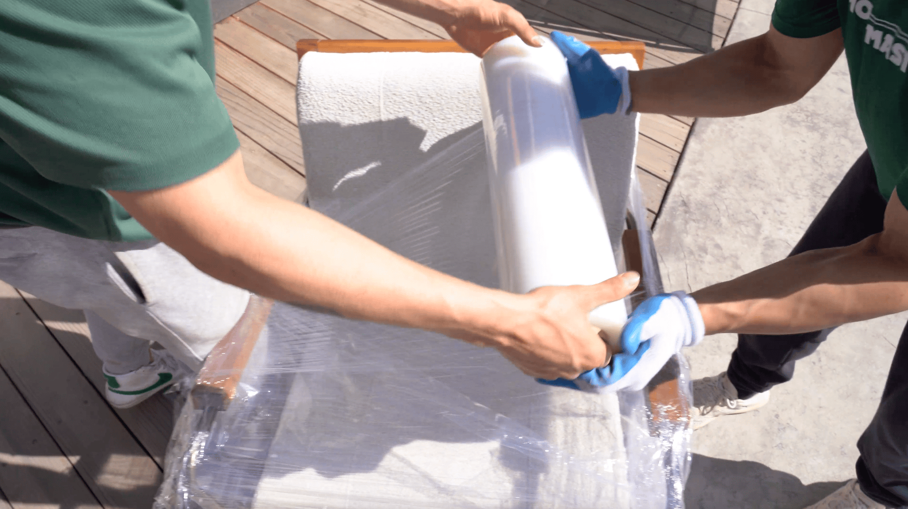 Professional movers wrapping furniture to protect it during a move